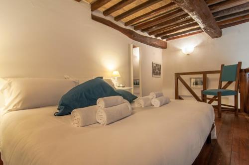 a bedroom with a large white bed with towels on it at Umbrian Concierge - Duomo Accommodations in Perugia