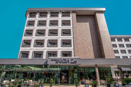 a tall building with a sign on it at Riviera Zen Hotel Adult Only in Alanya
