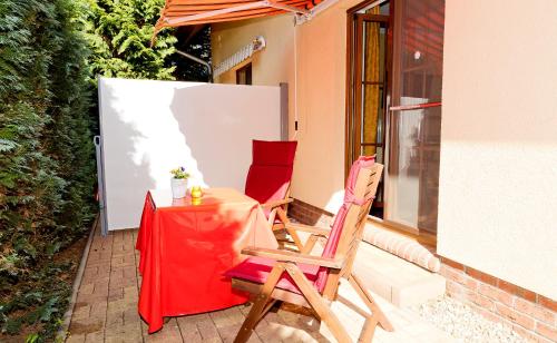 two chairs and a table on a patio at Hotel am Katharinenholz in Potsdam