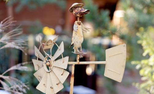 a bird perched on a pole next to a sign at Hotel am Katharinenholz in Potsdam