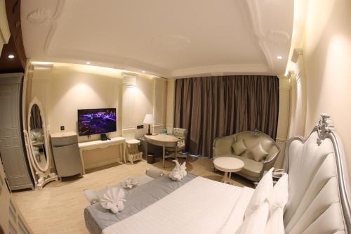 a hotel room with a bed and a tv at Regenta Central RS Chennai OMR SIPCOT in Chennai