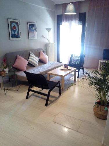 a living room with a couch and a table at Karditsa Home Sweet Home 80 τ.μ in Kardítsa
