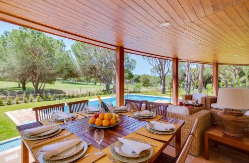a dining room with a table with fruit on it at OnJ Vilamoura in Quarteira