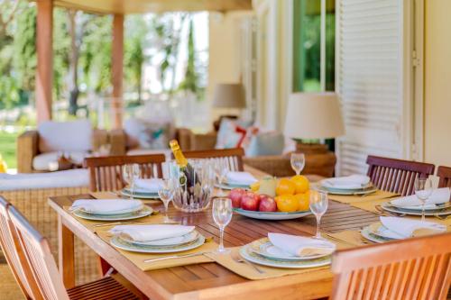 a wooden table with a plate of fruit on it at OnJ Vilamoura in Quarteira