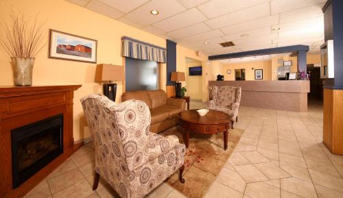a living room filled with furniture and a fireplace at St Christopher's Hotel in Channel-Port aux Basques