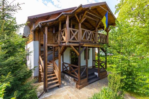 a tree house with a staircase leading up to it at Guest House Plai in Yaremche