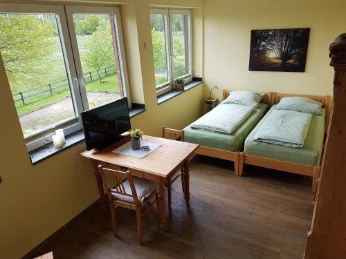 a room with two beds and a desk with a computer at Apartments Luisenhof in Krefeld