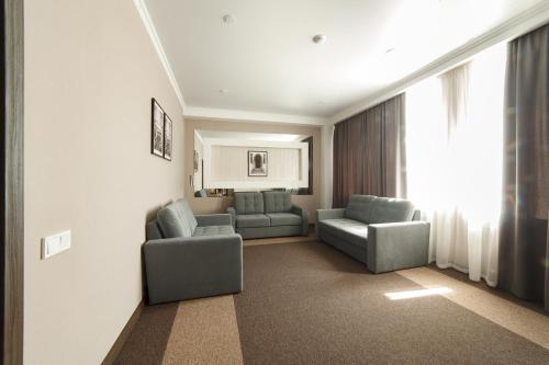 a living room with two chairs and a couch at Meridian in Karagandy