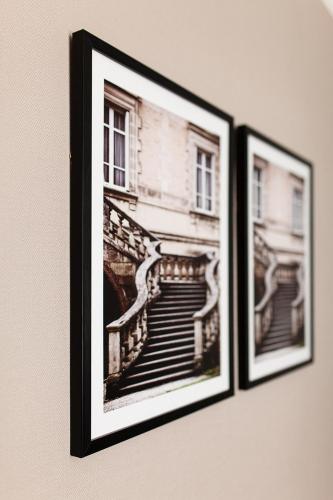two framed pictures of a staircase on a wall at Meridian in Karagandy