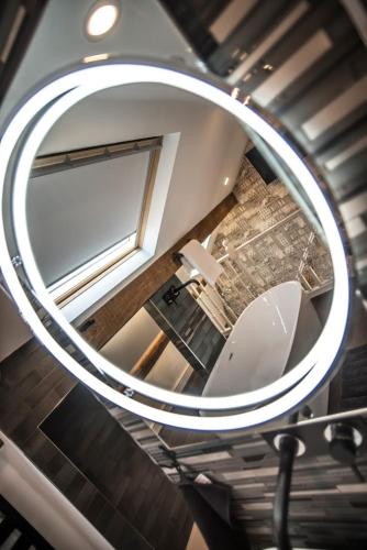 a mirror hanging from the ceiling of a bathroom at Arthur's Bar & Accommodation in Southport