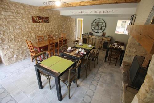 a dining room with wooden tables and chairs at LE RELAIS D'ARZAC in Cahuzac-sur-Vère