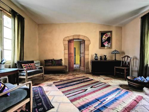 a living room with a couch and a table at La Bastide du Farfadet in Laudun
