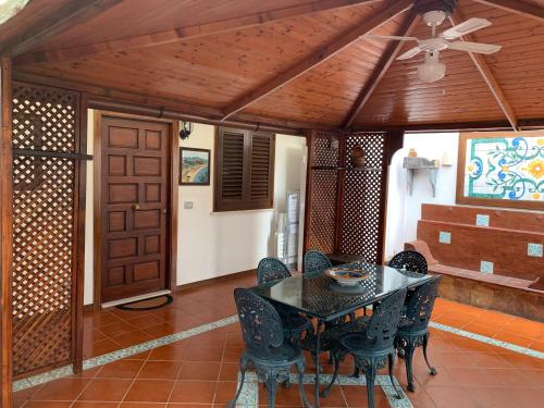 a dining room with a black table and chairs at Casa Vacanza NINA in Milazzo