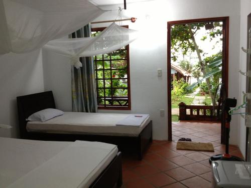Postel nebo postele na pokoji v ubytování Phu Quoc Kim - Bungalow On The Beach