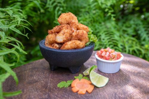 a bowl of food sitting on top of a table at Hotel Banana Azul - Adults Only in Puerto Viejo
