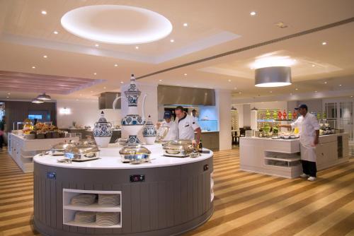 a group of chefs in a kitchen preparing food at Radisson Blu Resort & Thalasso Hammamet in Hammamet