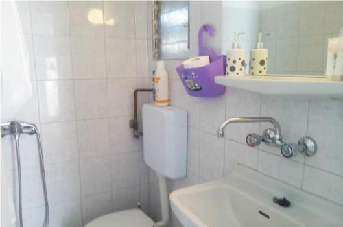 a bathroom with a toilet and a sink and a tub at CENTRAL TOWN STUDIO ON POROS in Poros
