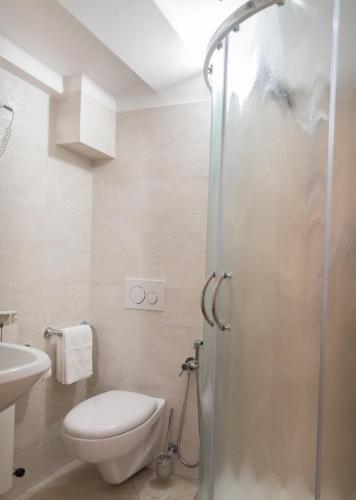 a bathroom with a toilet and a sink and a shower at La Piaggia in Assisi