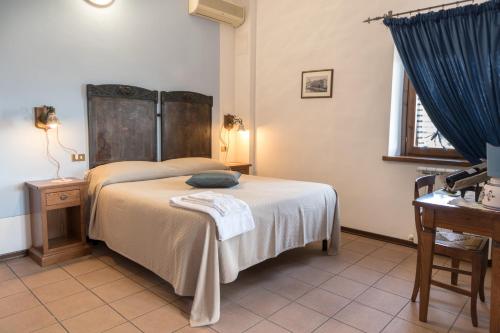 a bedroom with a bed and a blue curtain at La Piaggia in Assisi