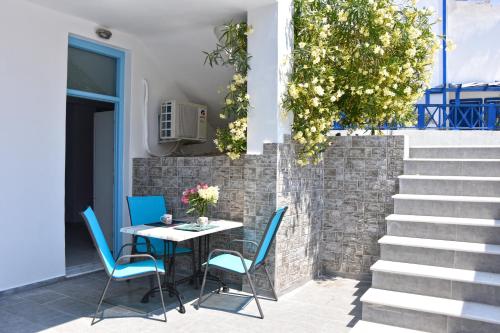 a table and chairs on a patio with stairs at Adelphi Apartments in Perissa