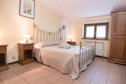 a bedroom with a large bed and a window at La Piaggia in Assisi