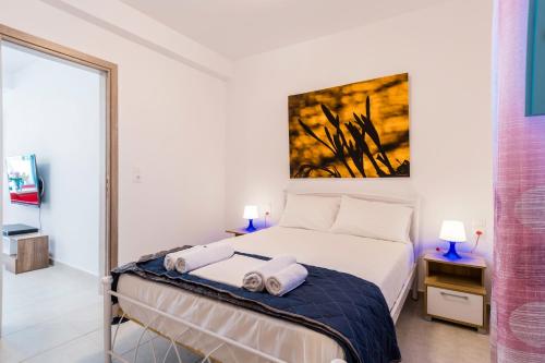 a bedroom with a bed with two towels on it at Adelphi Apartments in Perissa