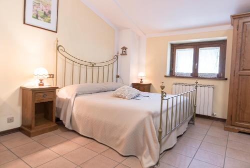 a bedroom with a large bed and a window at La Piaggia in Assisi