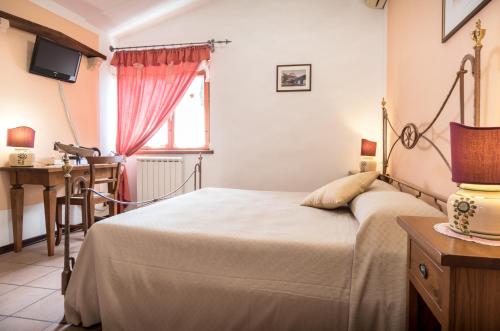 a bedroom with a bed and a window at La Piaggia in Assisi