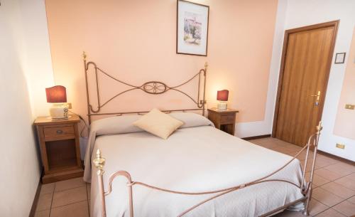 a bedroom with a bed and two night stands at La Piaggia in Assisi