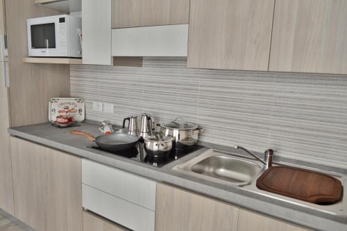 a kitchen with a sink and a counter top at Casa Comisso in Caorle