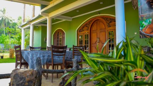 a dining room with a table and chairs at Gamagedara Resort in Dambulla