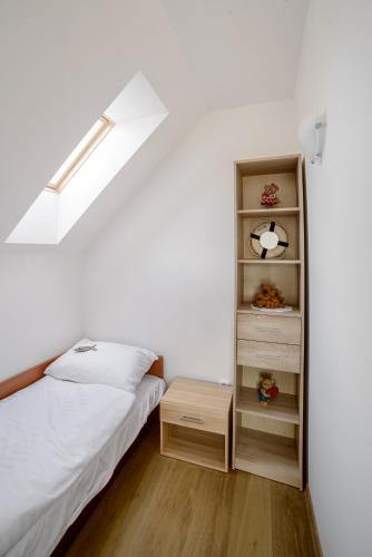 a bedroom with a bed and a book shelf at Amber Playa in Dębki