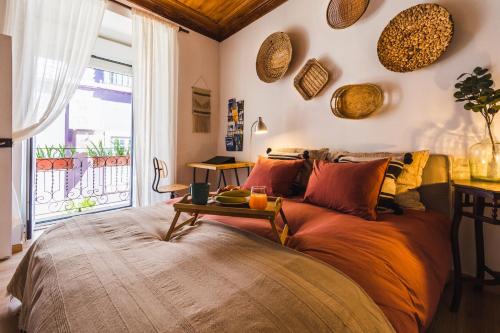a bedroom with a large bed with a table on it at Camões Lofty Boho Apartment in Setúbal