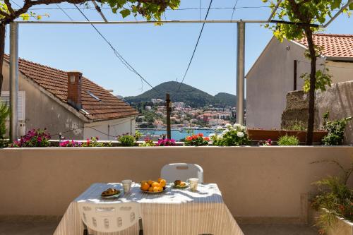 a table with a bowl of fruit on a balcony at Apartment Meet & Greet in Dubrovnik