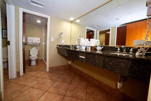 a hotel bathroom with a sink and a toilet at DeSoto Beach Hotel in Tybee Island