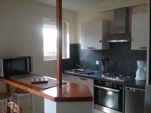 a kitchen with a sink and a stove top oven at Studio in La Trinité-sur-Mer