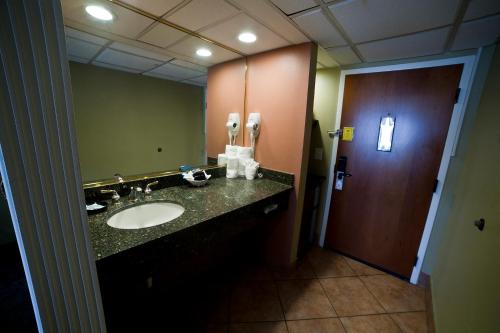a bathroom with a sink and a mirror at DeSoto Beach Hotel in Tybee Island