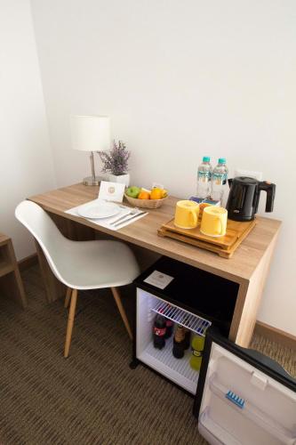 a wooden table with a bowl of fruit and water on it at Tierra Viva Miraflores Centro in Lima