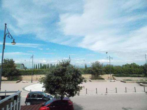 a parking lot with two cars parked in a parking lot at Appartamento in centro paese in Monterosi