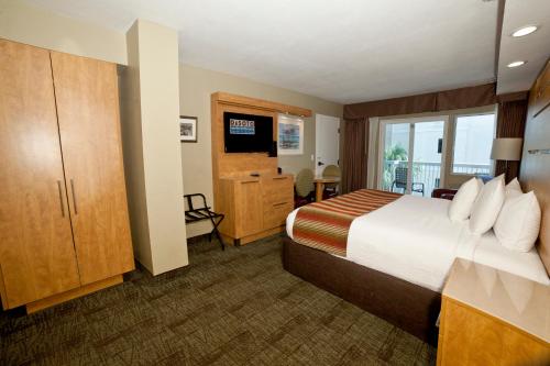a hotel room with a bed and a television at DeSoto Beach Hotel in Tybee Island