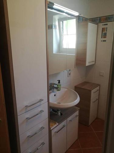 a bathroom with a sink and a mirror at Ein schöner Panorama Blick in Augsdorf