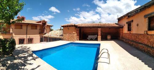 a swimming pool in the backyard of a house at Cortijo El Lerele in Cazorla