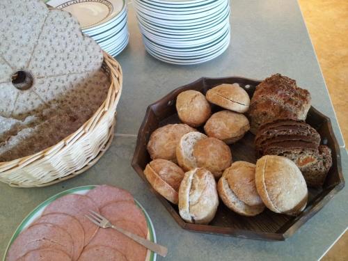 a table with a basket of bread and pastries at STF Orsa Hostel in Orsa