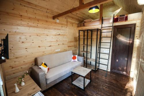 a living room with a couch and a wooden wall at BUKHRIANI in Kutaisi