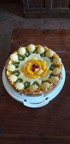 a cake on a white plate with flowers on it at Villa Sorrentina in Alghero