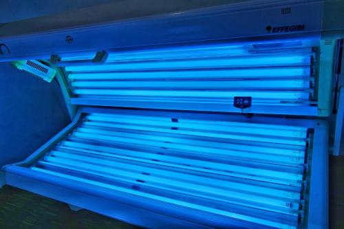 a refrigerator with blue lights in a room at Hotel Tridentum in Cesenatico