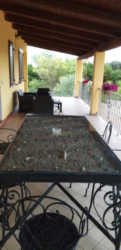a table on a patio with a tableablish at Villa Sorrentina in Alghero