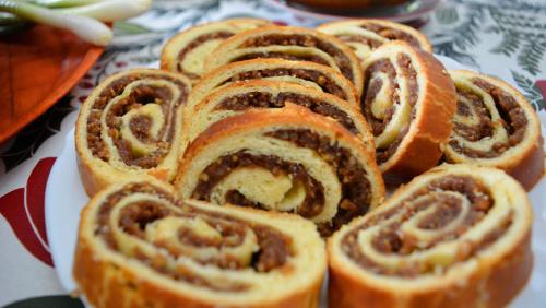 a pile of cinnamon rolls sitting on a plate at Casa Papițu in Vadu Izei