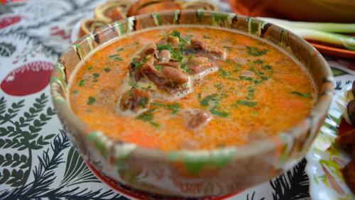 a bowl of soup sitting on a table at Casa Papițu in Vadu Izei