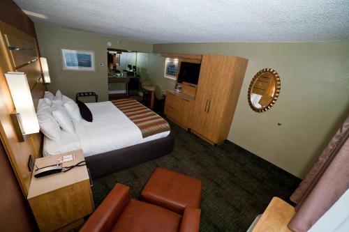 a hotel room with a bed and a chair at DeSoto Beach Hotel in Tybee Island